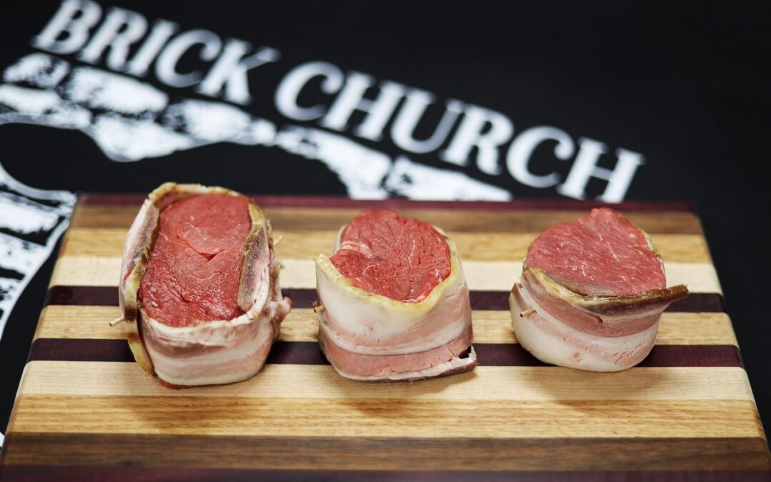 Photo of bacon wrapped steaks on cutting board